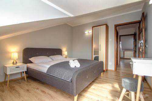 a bedroom with a bed with two towels on it at Duży apartament Mielno in Mielno