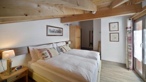 a bedroom with a large bed with wooden ceilings at Le Chamois in Les Diablerets