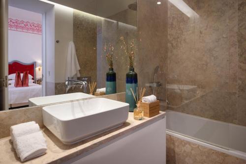 a bathroom with a white sink and a shower at Once Upon Lisboa Family Units in Lisbon