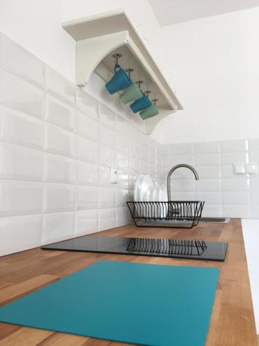 a kitchen with a blue rug and a sink at ZACISZE in Karłów
