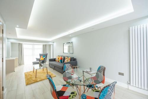 a living room with a glass table and chairs at Headley House in Reading