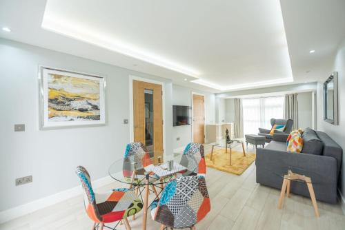 a living room with a glass table and chairs at Headley House in Reading