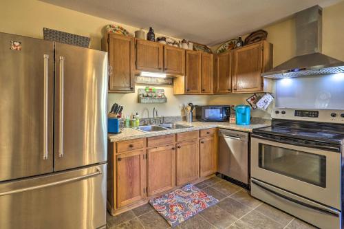 a kitchen with wooden cabinets and stainless steel appliances at Nature Escape in Wytheville with Covered Porch! in Wytheville