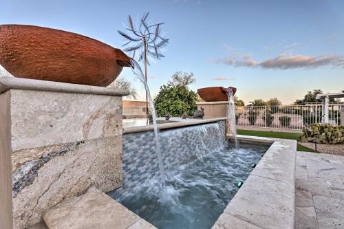 a water feature in a yard with a windmill at Modern Sun City Studio Near Deer Valley Golf in Sun City West