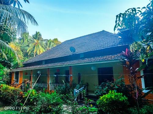 a small house in the middle of a garden at Country Side Inn Portuguese Guest House in Cuelim