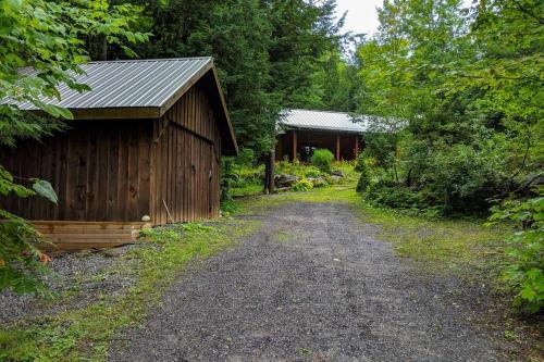 a dirt road next to a wooden building at Chalet Le Boisé in Wakefield