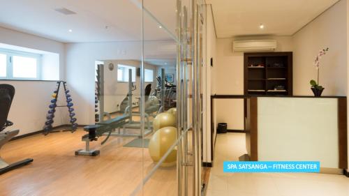 a gym with exercise equipment and a glass wall at Vila Galé Rio de Janeiro in Rio de Janeiro