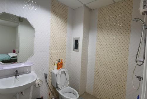 a bathroom with a shower and a toilet and a sink at TD Bangkok in Bangkok