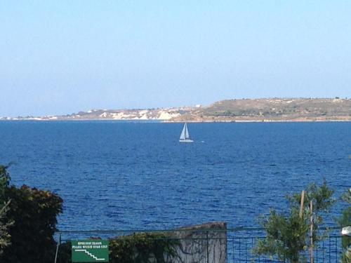 a sailboat in the middle of a large body of water at Studios Angeliki in Lassi
