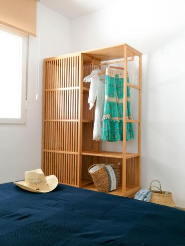a room with a bed with a hat and a closet at APARTAMENTOS MAITE in Peniscola