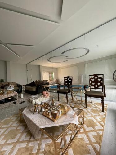 a living room with a couch and a table and chairs at شالية فاخر بمسبح خاص بمكة المكرمة in Makkah