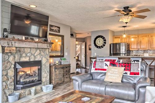 a living room with a couch and a fireplace at Updated Seven Devils Condo with Deck and Mountain View in Seven Devils