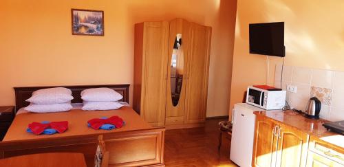 a room with a bed with towels on it at Hercules in Truskavets