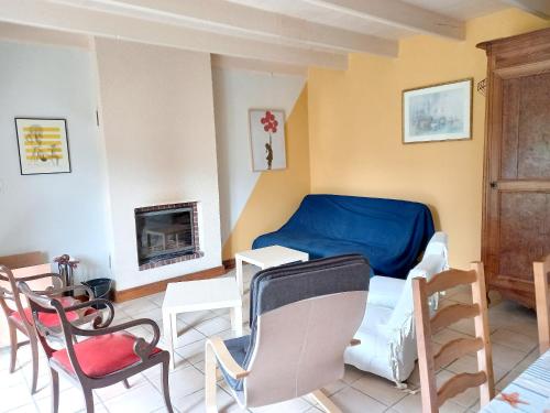 a room with a bed and a table and chairs at Maison confortable à Plehedel avec cheminée in Pléhédel