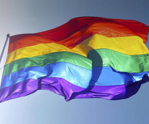 a colorful rainbow flag flying in the sky at Casa Nudista - LGBT Hotel in Zipolite