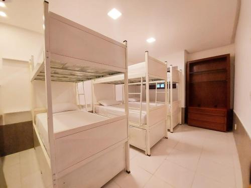 two bunk beds in a room with a hallway at iHOSTEL ALDEOTA in Fortaleza