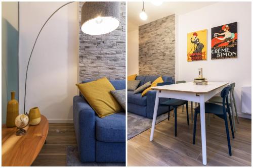 een woonkamer met een blauwe bank en een tafel bij SPAZIO M&M CELLINI 3 in Milaan