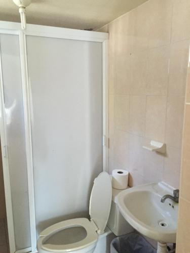 a bathroom with a toilet and a sink at Nichos Beach Villas in Playa Azul