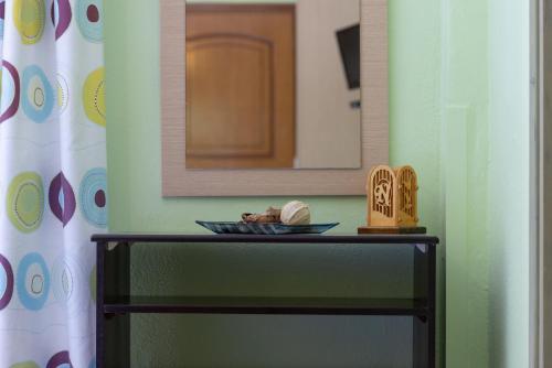 a table in a room with a mirror and a bowl at Niriides in Porto Koufo