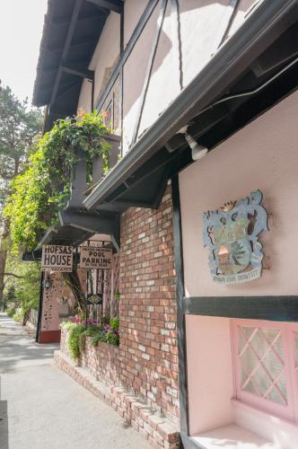 a house with a sign on the side of a building at Hofsas House Hotel in Carmel