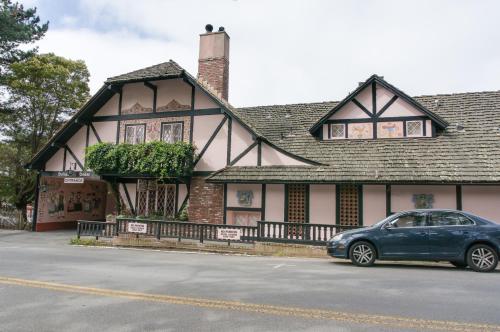 a blue car parked in front of a house at Hofsas House Hotel in Carmel