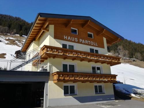 a building with a sign that reads huss parolis particular at Haus Partoll in Kappl