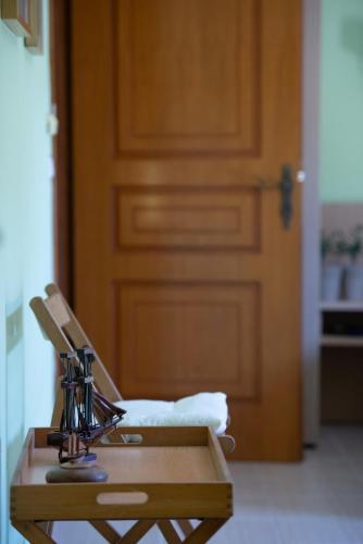 a table with a sewing machine sitting in front of a door at Niriides in Porto Koufo