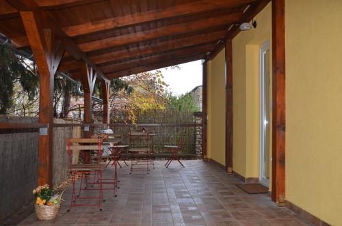 a patio with chairs and tables on a building at Alexandra Apartman Sárvár in Sárvár