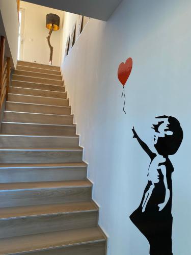 a wall mural of a woman holding a heart balloon at Golf Residenz Längsee in Sankt Georgen am Längsee