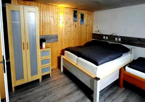 a bedroom with two beds and a door in it at Exklusive Naturoase direkt am Ars Natura Wanderweg mit Panoramablick auf Melsungen in Melsungen