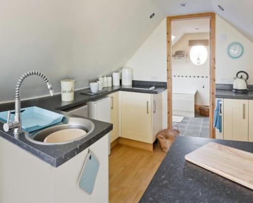 a kitchen with a sink and a counter top at Robins Nest - A great place to Explore! 