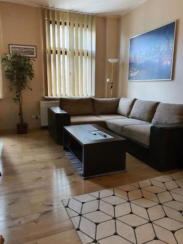 a living room with a couch and a coffee table at Mostowa 3 in Bydgoszcz