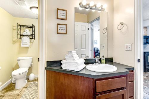 a bathroom with a sink and a toilet and a mirror at Harbor Village 14-Plex Condo 120 in Garden City