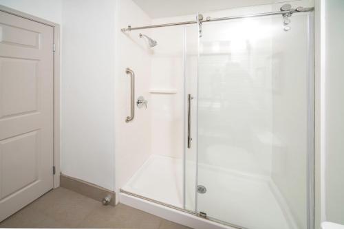 a shower with a glass door in a bathroom at Country Inn & Suites by Radisson, Stone Mountain, GA in Stone Mountain