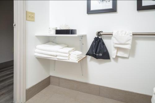 a bathroom with white towels on a wall at Country Inn & Suites by Radisson, Stone Mountain, GA in Stone Mountain