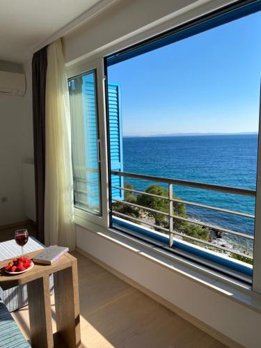 a room with a large window with a view of the ocean at RIA Lungomare in Rijeka