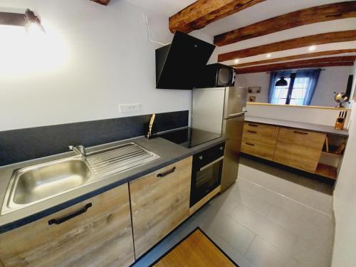 a kitchen with a sink and a counter top at Appart'Heim in Colmar