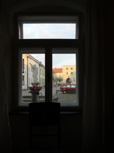 a window with a view of a street outside at Apartmány U sv. Floriána in Slavonice
