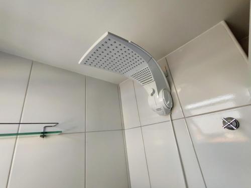 a shower with a shower head in a bathroom at Flat 204 Smart Residence Teresina in Teresina