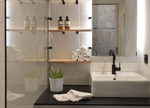 a bathroom with a sink and a counter with a mirror at Plaisance Appartements & Suites - Bouguenais Apt in Bouguenais