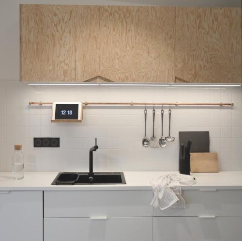 a kitchen with a sink and a counter top at PLAISANCE Bouguenais - Appartement Nantes - PARKING GRATUIT in Bouguenais