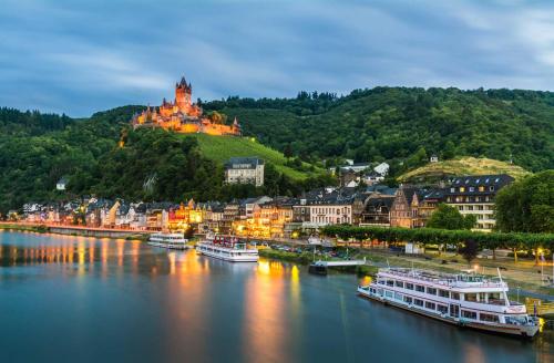 a town on the river with boats in the water at Ferienwohnung Luna in Cochem