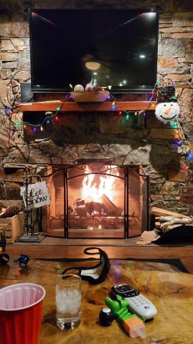 a fireplace with a television and remote controls on a table at Gondola Lodge & Tahoe Beach Club in South Lake Tahoe