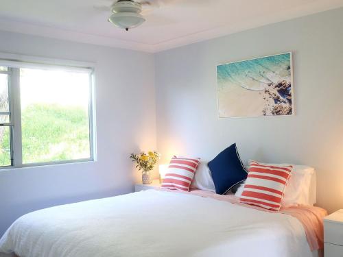 Ένα ή περισσότερα κρεβάτια σε δωμάτιο στο The Beach House
