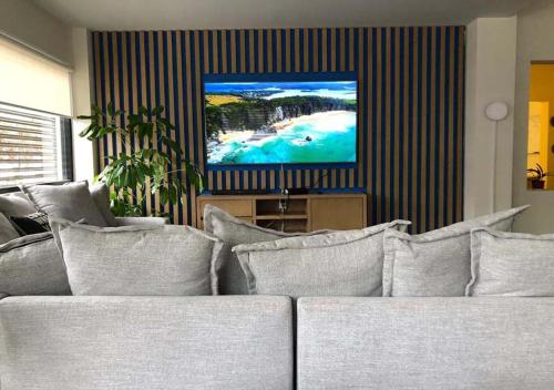 a living room with a couch and a tv at Colmena Hotel CDMX Tonala in Mexico City