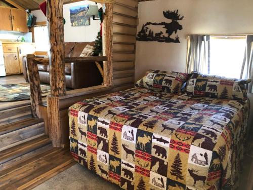 a bedroom with a bed in a log cabin at Riverbend Resort in South Fork