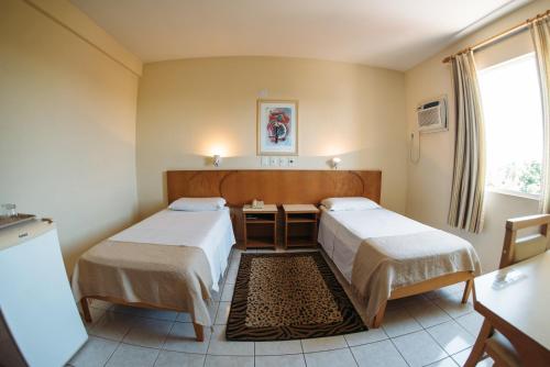 Postel nebo postele na pokoji v ubytování Hotel Caverá