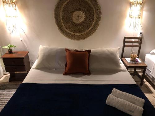 a bedroom with a large bed with a pillow on it at Kûara Pipa in Pipa