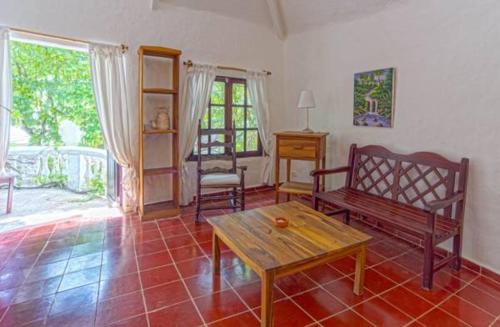 a living room with a bench and a table at Hotel Atlantis in Las Terrenas