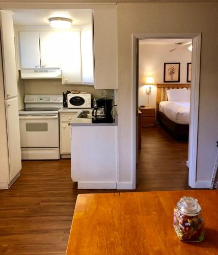 a room with a kitchen and a bedroom with a bed at Cold Creek Inn in Mount Shasta
